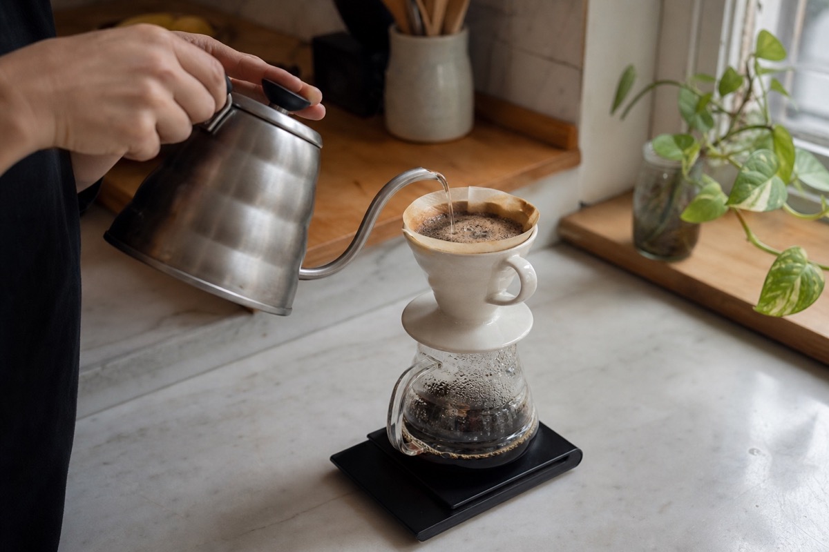 Pour-over coffee brewing in a bright home kitchen